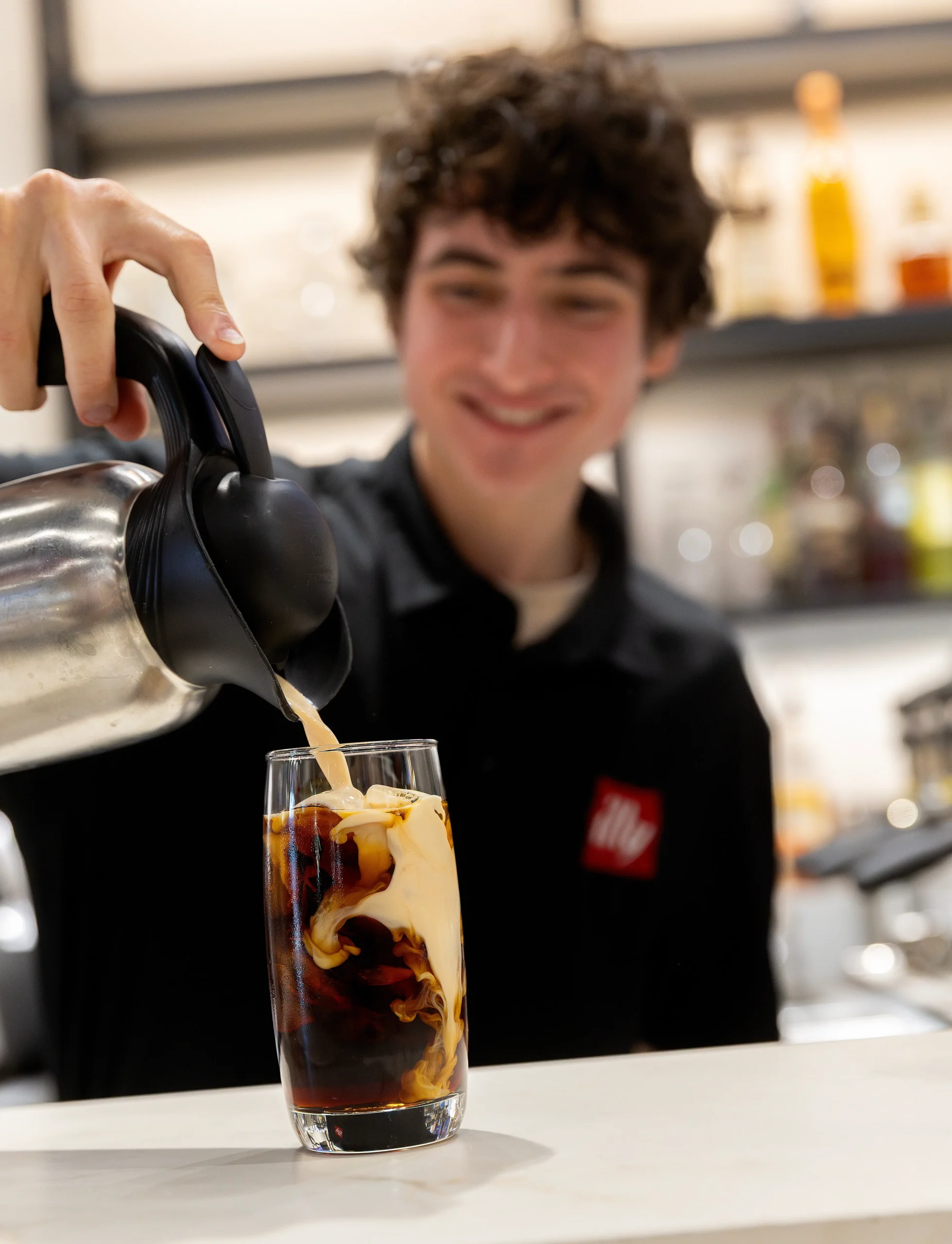 illy employee pouring cold coffee